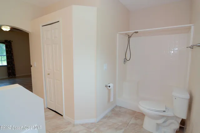 a bathroom with a shower and a toilet