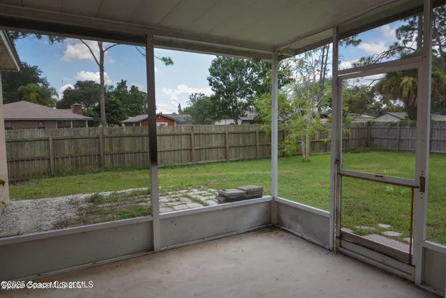 a view of a porch with furniture and garden