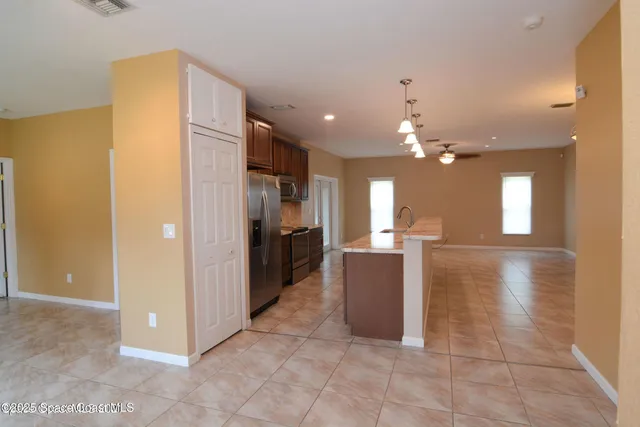 a view of a kitchen with a refrigerator and a sink