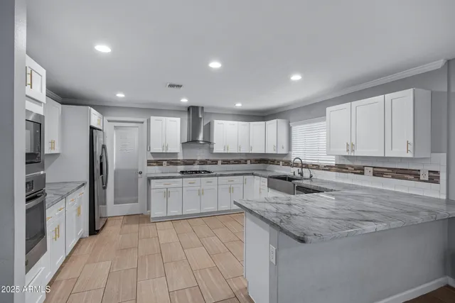 a kitchen with stainless steel appliances granite countertop a sink and cabinets