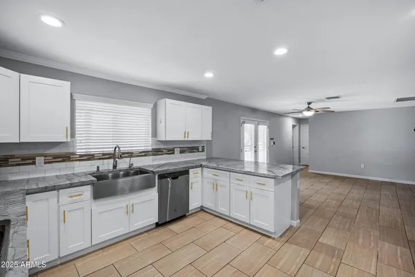 a kitchen with a refrigerator sink and stove