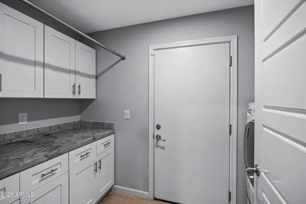 an empty room with closet and windows