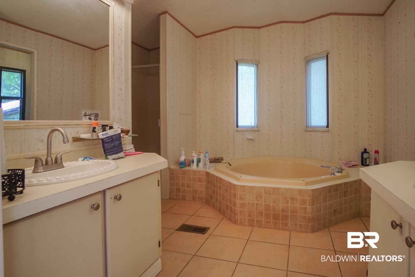 9190 County Road 97 Elberta, AL 36530 - Photo 30 of 53 Bathroom featuring tiled bath, tile patterned floors, vanity, and a textured ceiling