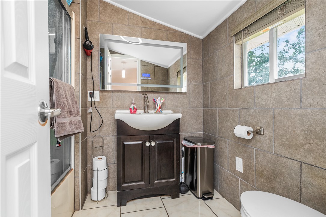 358 Finley Road Easley, SC 29642 - Photo 12 of 20 This bathroom features sleek tile walls and floors, complemented by a modern vanity.