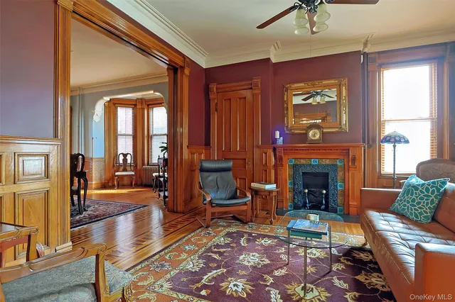 a dining room with furniture a chandelier and wooden floor
