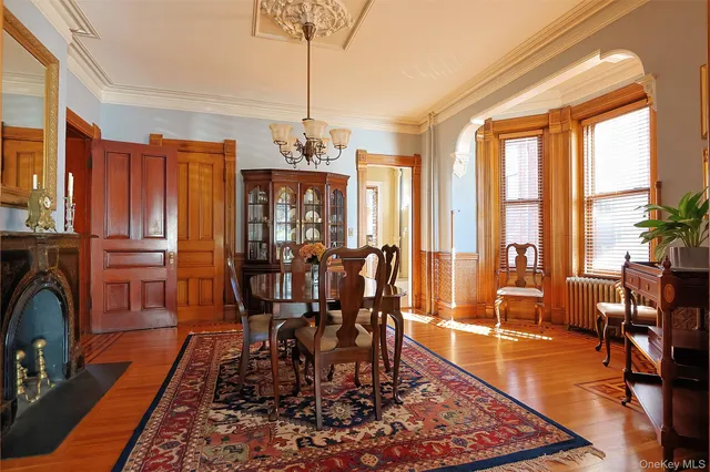 a living room with furniture a chandelier and a flat screen tv