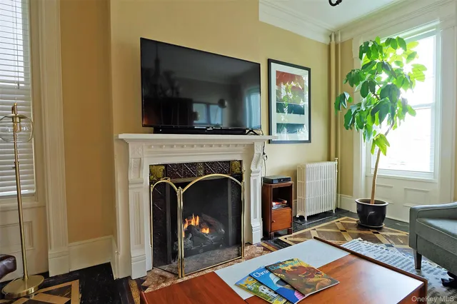 a living room with a table and a fireplace