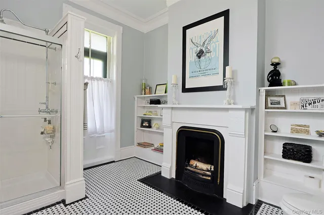 a kitchen with a refrigerator wooden floor and white cabinets