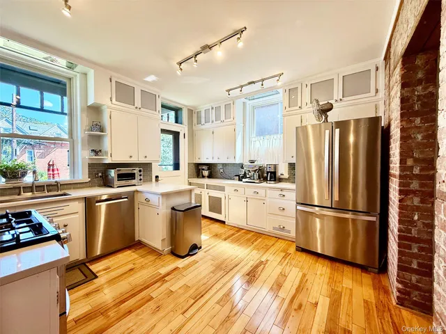 a kitchen with granite countertop a stove and cabinets