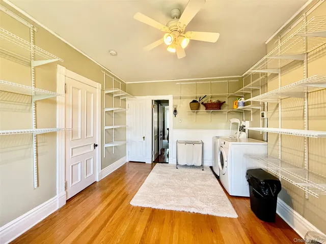 a living room with a bed furniture and a flat screen tv