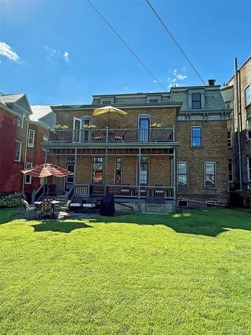 a view of a house with swimming pool and yard