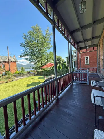 a view of a chairs and table in patio with wooden floor