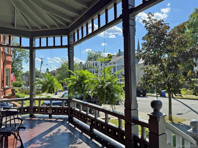 a living room with furniture a fireplace and large windows