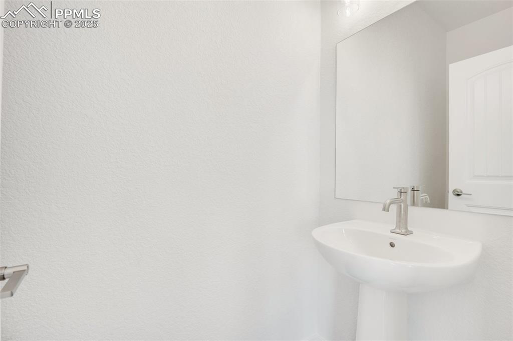 8156 Manor House Way Colorado Springs, CO 80908 - Photo 16 of 35 a bathroom with a sink and a mirror