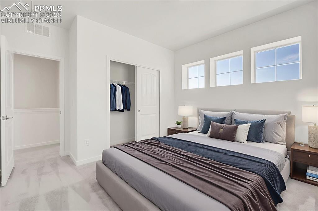 8156 Manor House Way Colorado Springs, CO 80908 - Photo 21 of 35 a bedroom with a bed and painting on the wall