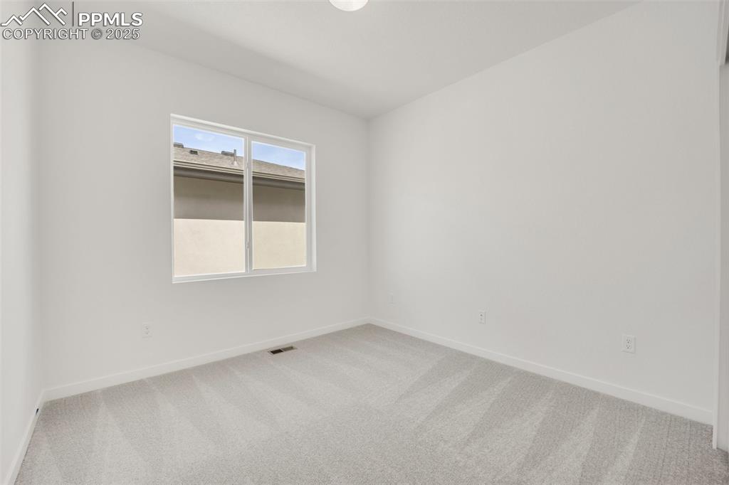 8156 Manor House Way Colorado Springs, CO 80908 - Photo 22 of 35 a view of an empty room with a window