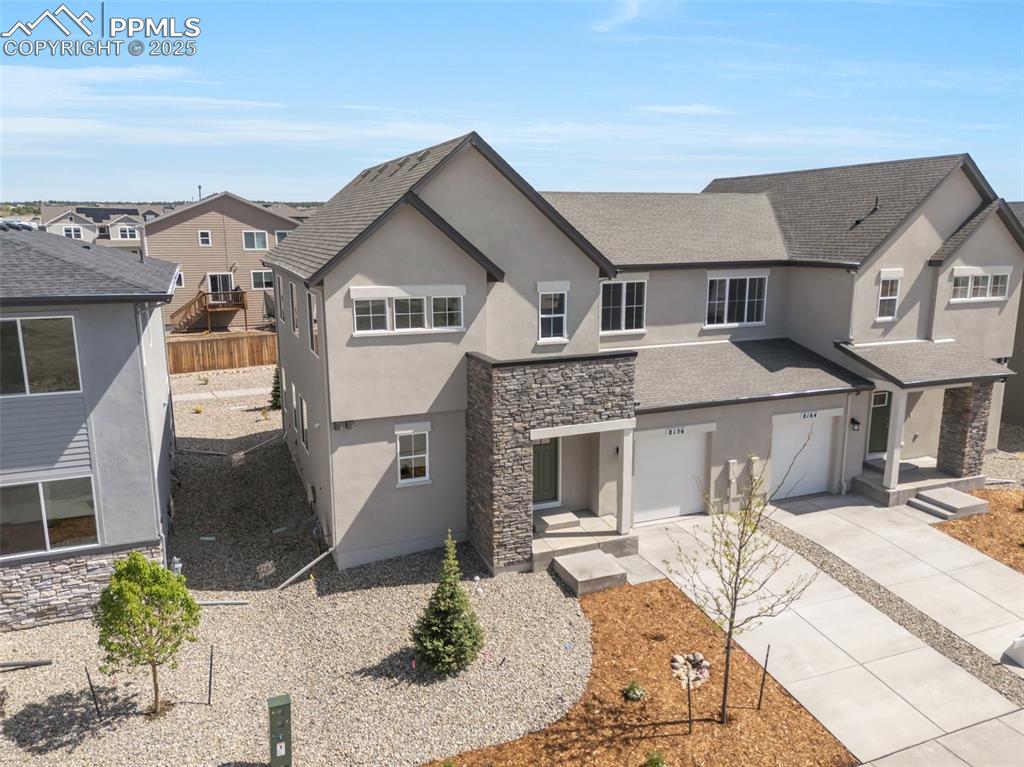 8156 Manor House Way Colorado Springs, CO 80908 - Photo 3 of 35 a front view of a house with a yard