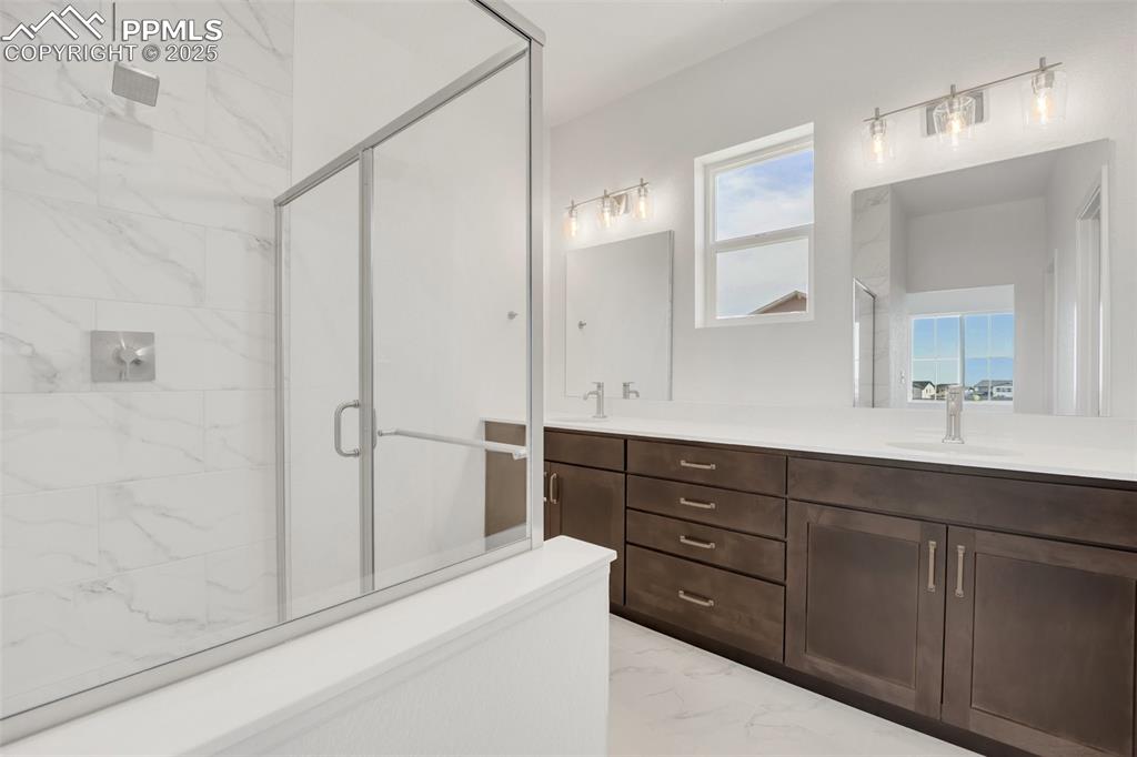 8156 Manor House Way Colorado Springs, CO 80908 - Photo 32 of 35 a bathroom with a sink and a mirror