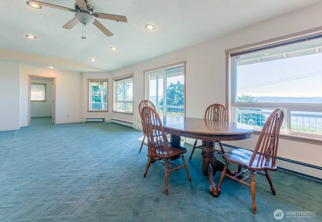 a view of a dining room with furniture window and outside view