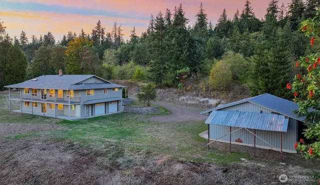 a backyard of a house with wooden fence and trees