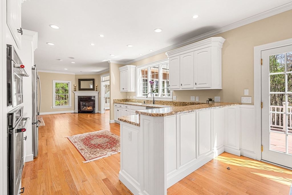 10 Sawyer Lane Middleton, MA 01949 - Photo 13 of 46 a kitchen with stainless steel appliances granite countertop a refrigerator and a stove top oven