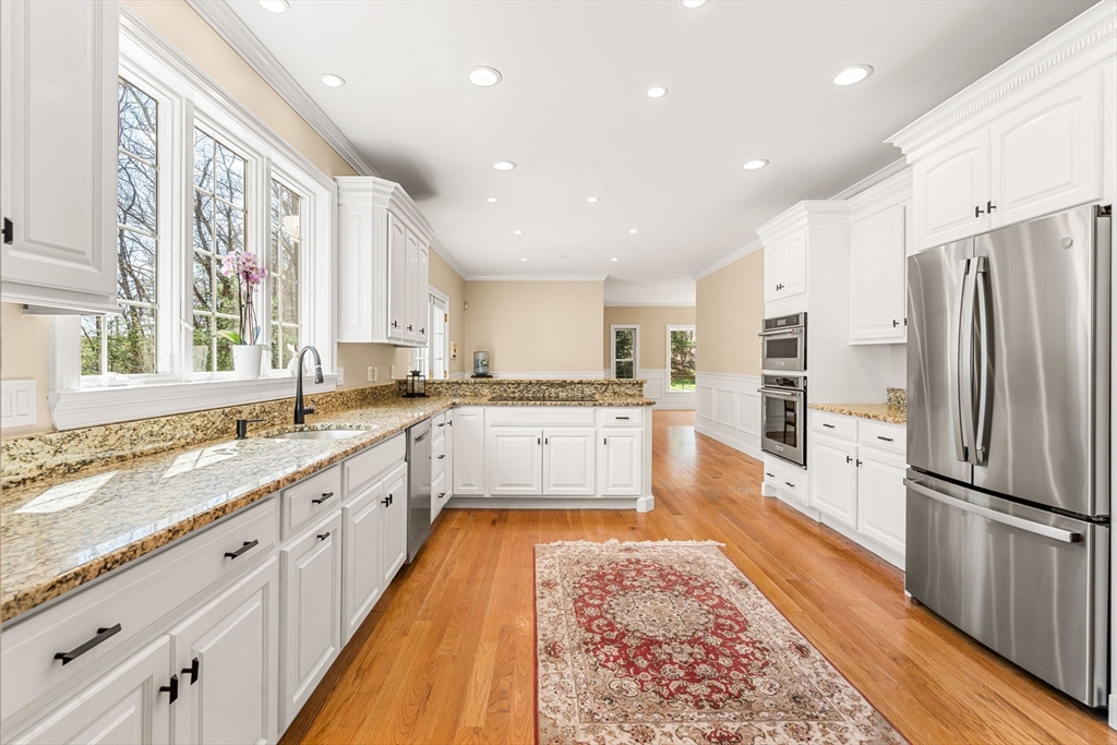 10 Sawyer Lane Middleton, MA 01949 - Photo 14 of 46 a large kitchen with stainless steel appliances granite countertop a refrigerator and a stove top oven