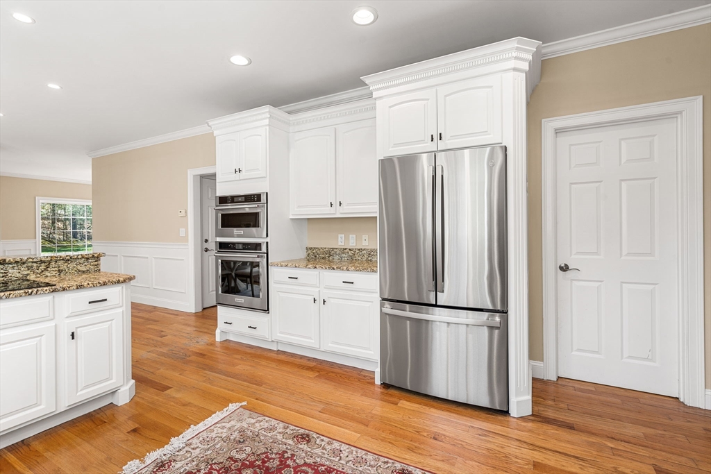 10 Sawyer Lane Middleton, MA 01949 - Photo 16 of 46 a kitchen with granite countertop stainless steel appliances a refrigerator and cabinets