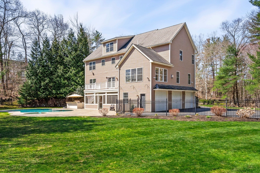 10 Sawyer Lane Middleton, MA 01949 - Photo 2 of 46 a front view of a house with garden and trees