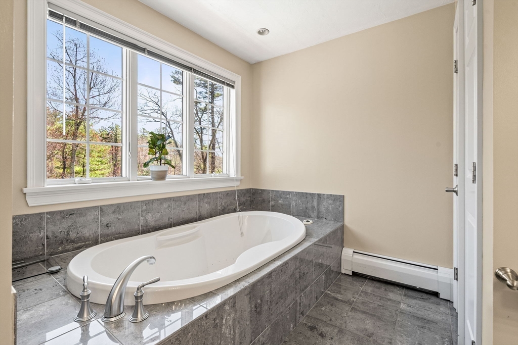 10 Sawyer Lane Middleton, MA 01949 - Photo 30 of 46 a white bath tub sitting next to a window