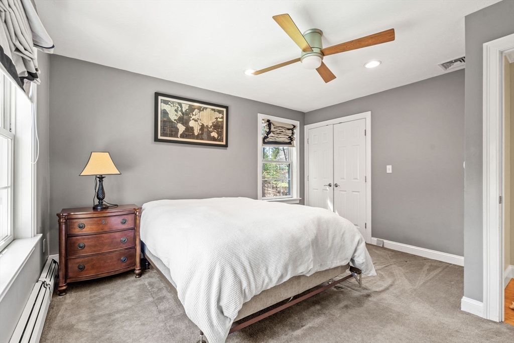 10 Sawyer Lane Middleton, MA 01949 - Photo 32 of 46 a bedroom with a bed and a lamp
