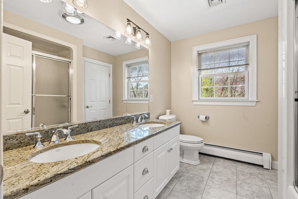 10 Sawyer Lane Middleton, MA 01949 - Photo 33 of 46 a bathroom with a granite countertop double vanity sink a mirror and a toilet