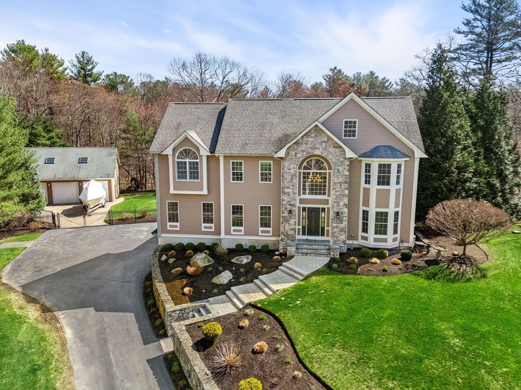 10 Sawyer Lane Middleton, MA 01949 - Photo 6 of 46 a front view of a house with garden