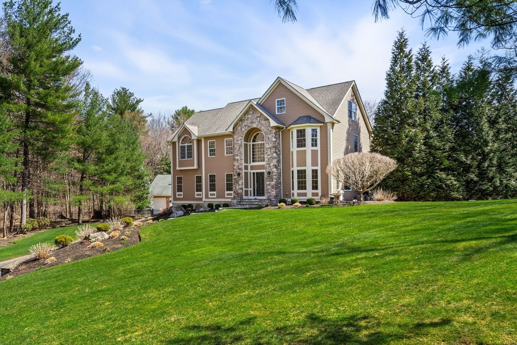 10 Sawyer Lane Middleton, MA 01949 - Photo 7 of 46 a front view of a house with a garden