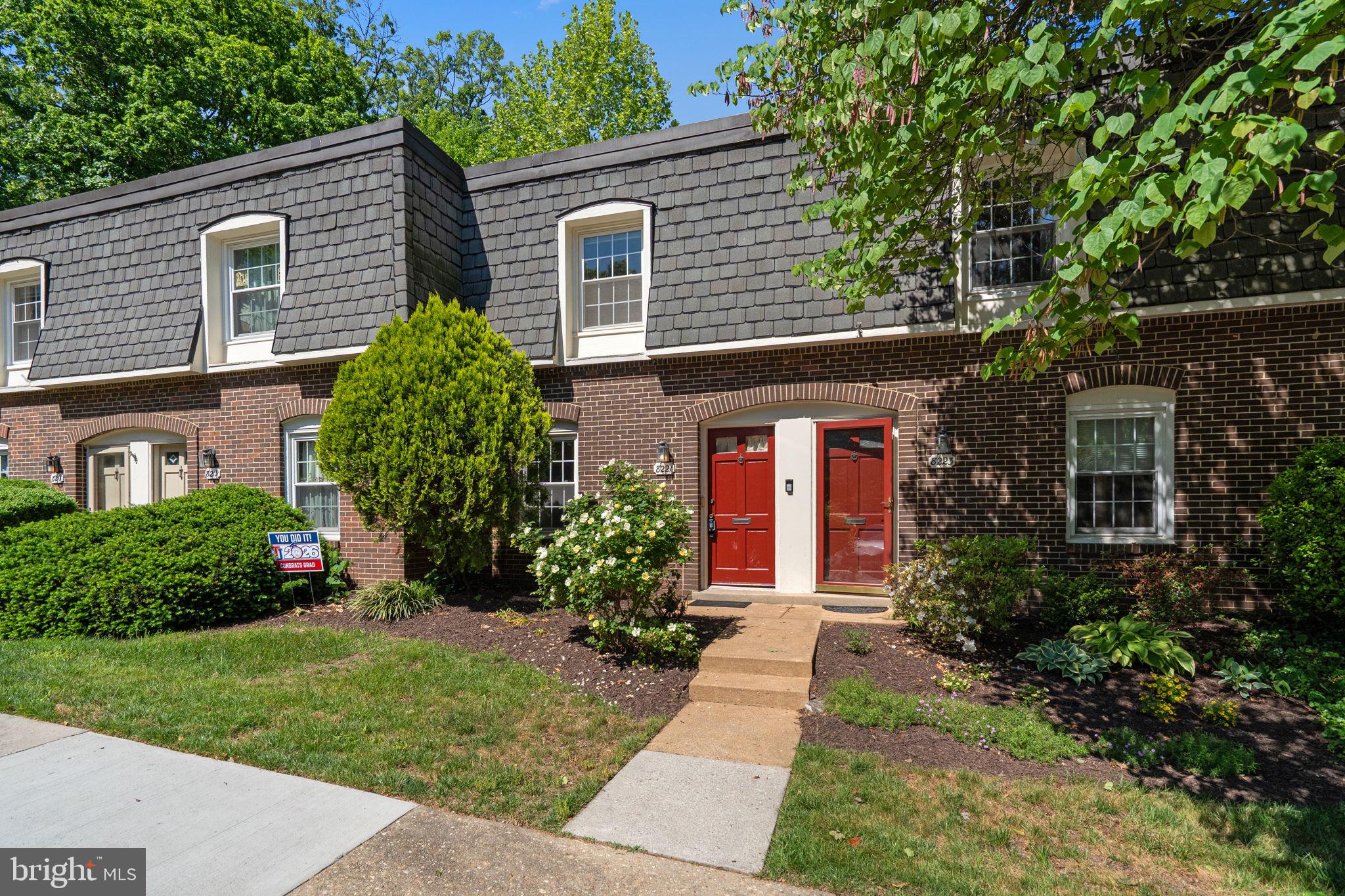 8221 Tory Road, Unit 150 Springfield, VA 22152 - Photo 2 of 36 Charming brick townhouse with lush greenery.