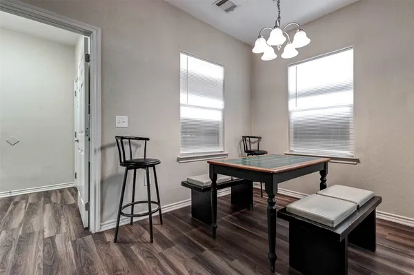 a view of a room that has a table and chairs in it