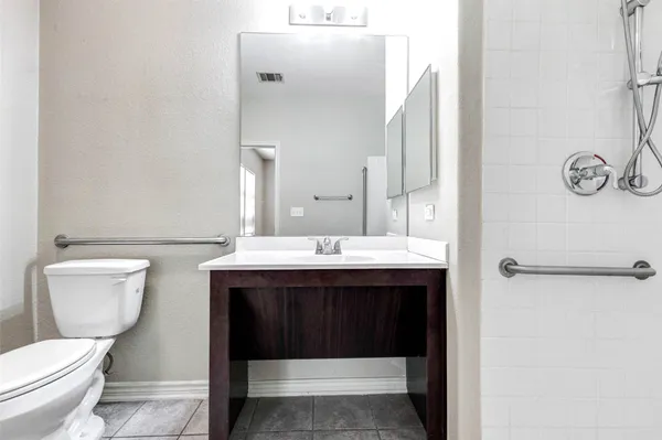 a bathroom with a sink a toilet and a mirror