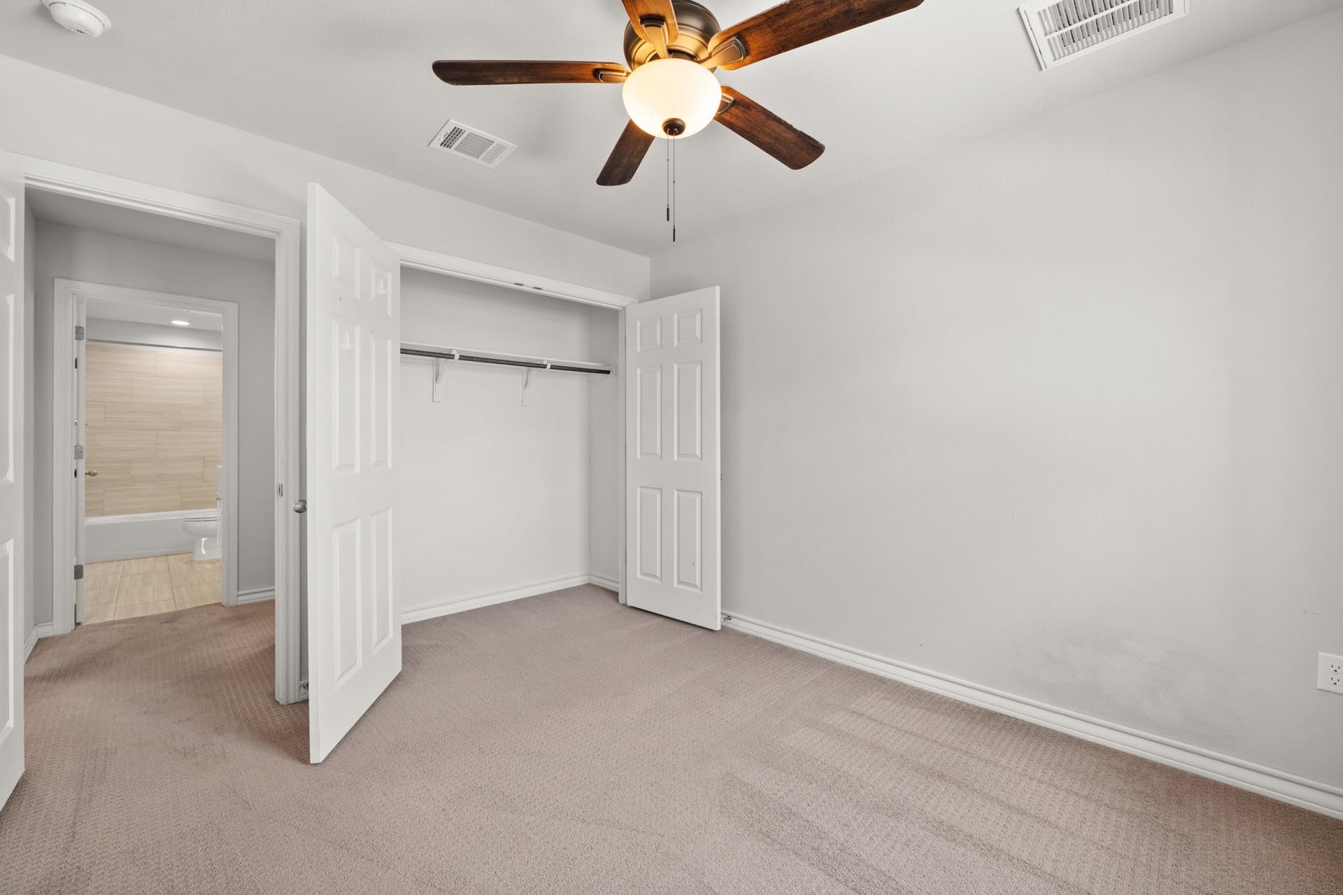 5107 Lemon Tree Path, Unit 127 Austin, TX 78723 - Photo 26 of 40 an empty room with closet and a chandelier fan
