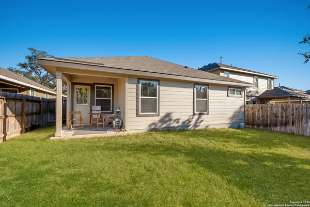 a view of a house with backyard and porch