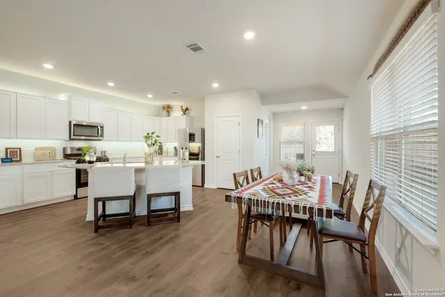 a view of a dining room with furniture and wooden floor
