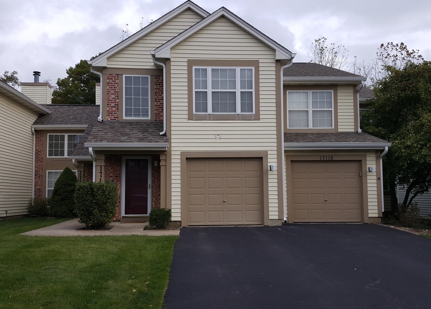 17116 West Cunningham Court, Unit 4A Grayslake, IL 60030 - Photo 1 of 1 a front view of a house with a garden and yard