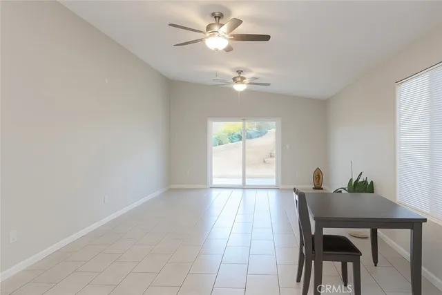 a view of a dining room with furniture and a chandelier fan