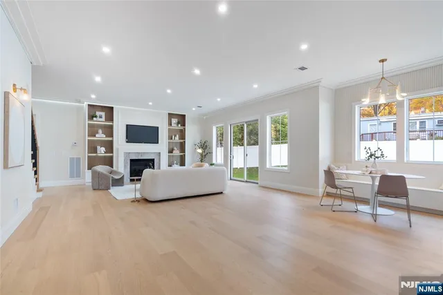 a living room with furniture a flat screen tv and a large window