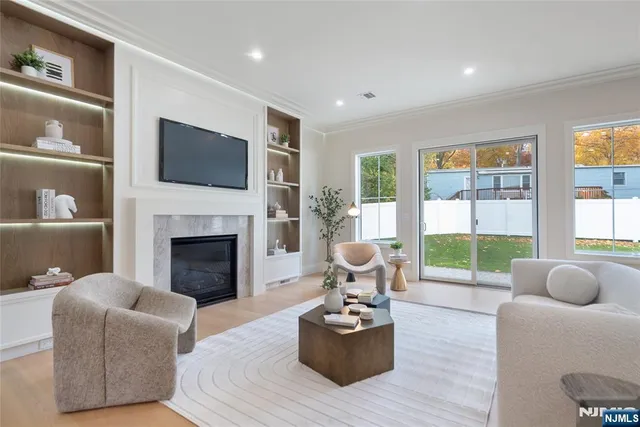a living room with furniture a flat screen tv and a fireplace