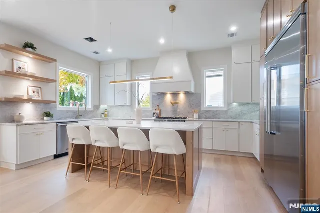 a kitchen with kitchen island granite countertop wooden cabinets and counter space