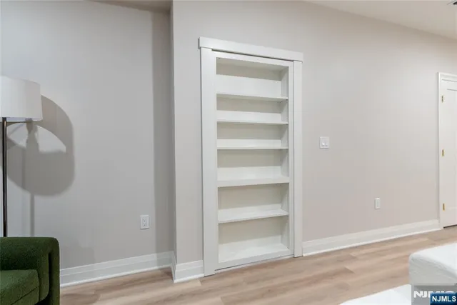 a view of a room with wooden floor