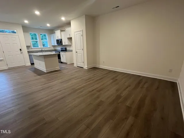 a view of an entryway with wooden floor