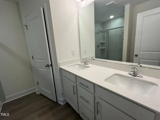 a bathroom with a glass door shower