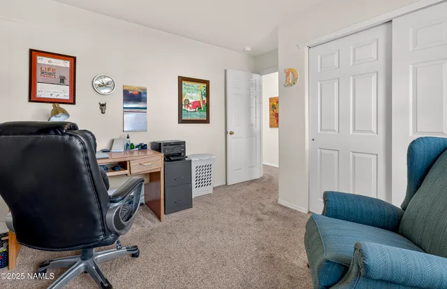 a view of a livingroom with workspace and a couch