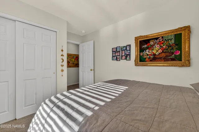 a bedroom with a bed and wall painting