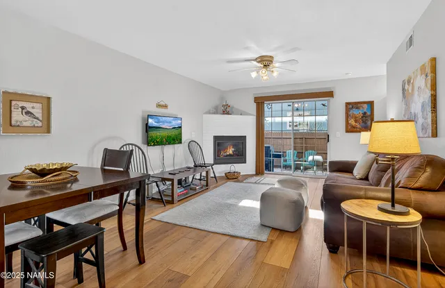 a living room with furniture a fireplace and a window